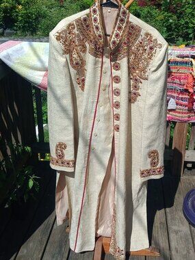 beige embroidered bridal sherwani with intricate floral and paisley threadwork
